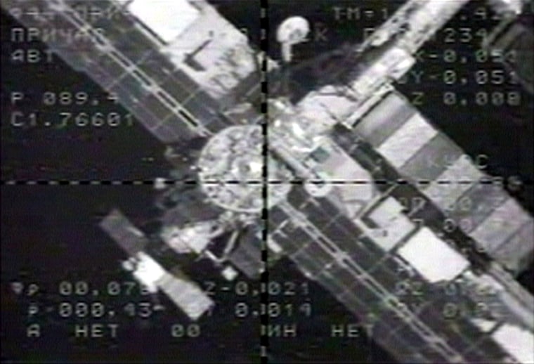 A video view from a Progress cargo ship shows the international space station's docking port during Thursday's approach, with Russian engineering data overlaying the image.