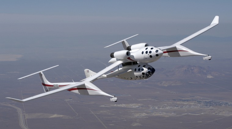 SpaceShipOne is mated to the bottom of its carrier airplane, the White Knight, in this aerial view.