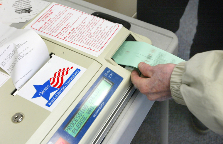 A voter submits his ballot to a punch-card reader in Chicago during a primary election in March.