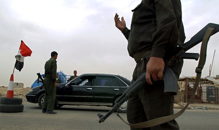 Iraqi members of the Fallujah Brigade conduct security checks on vehicles entering and leaving Fallujah on May 11.