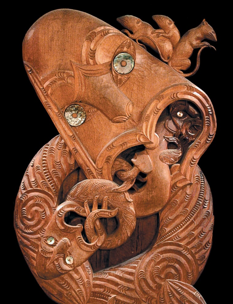 A wood carving depicts an ancestral Polynesian colonist of Oceania. Riding on his shoulder are Pacific rats, which were often transported in canoes as a food source.