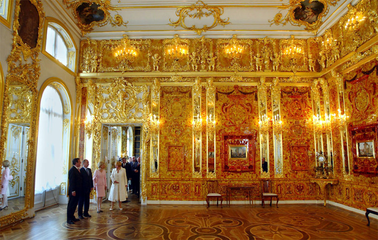 ** FILE ** German Chancellor Gerhard Schroeder, Russian President Vladimir Putin, Doris Schroeder Koepf and Lyudmila Putin , from left, admire the reconstructed Amber Room in the Catherine Palace in St. Petersburg, Russia, Saturday, May 31, 2003.  The US$8 milion reconstruction of the famed treasure, which was looted by the Nazis and went missing during the World War II, was partly funded by the German gas company, Ruhrgas.  (AP Photo/Alexander Zemlianichenko)