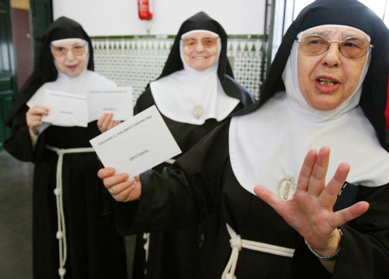 A group on nuns prepare to cast their votes Sunday at an election station in Cordoba, Spain, during European Parliamentary elections.