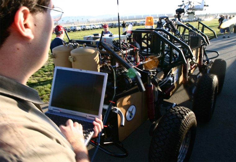 March 8, 2004 - California Speedway, Fontana, California - Denny Gudea uses a laptop to drive