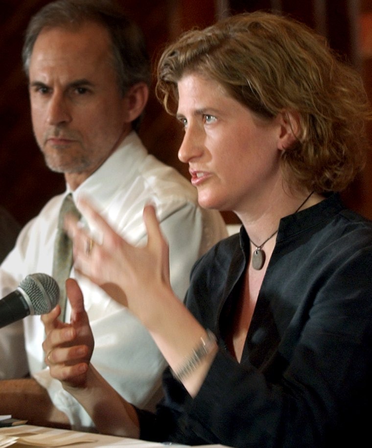 Freelance photographer Molly Bingham, sitting beside Newsday editor Jim Rupert, talks with reporters in Jordan after her release from Abu Ghraib on April 2, 2003. Bingham and Rupert were among the group of journalists being released from an Iraqi prison.