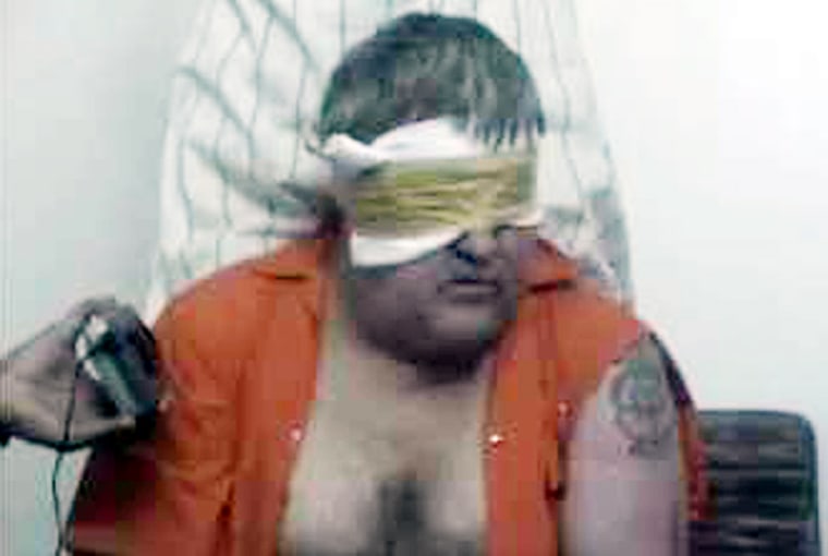 This image taken from an Islamic website, Tuesday June 15, 2004 shows a frame from a video of a blindfolded American hostage being held in Saudi Arabia. Paul Johnson, 49, of Stafford Township, N.J., was abducted Saturday by a group calling itself al-Qaida in the Arabian Peninsula. The organization is believed to be headed by al-Qaida's chief in the kingdom, Abdullah-aziz el-Moqrin. The website also displays Johnson's Lockheed Martin identification card. Johnson was employed by Lockheed Martin and worked on Apache helicopters. (AP Photo)