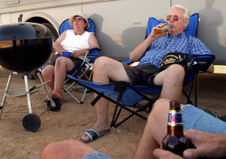 Lynn (left) and Fay Plank of Eugene, Oregon, relax outside their motorhome in the RV area at Mojave Airport, Saturday. The were the first RV'ers to arrive at the airport to watch Monday's launch of SpaceShipOne.