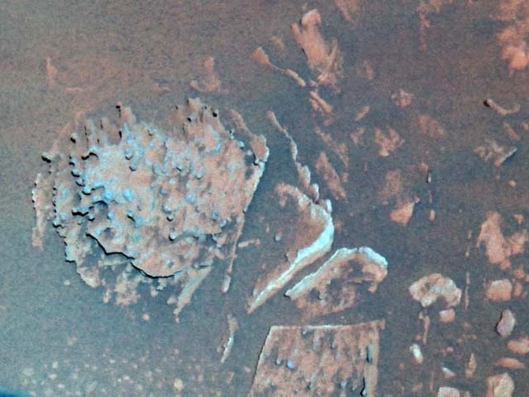 A color image of the rock "Pot of Gold" (middle left) taken by Spirit. The rock's nugget-like features and hematite composition have perplexed Mars researchers.