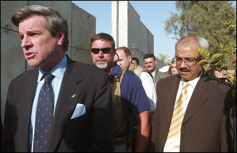 Paul Bremer, left, and Waleed Aumran, Governor of the city of Hilla, right, prepare to meet the press. Bremer visited Hilla, in southern Iraq on Thursday.
