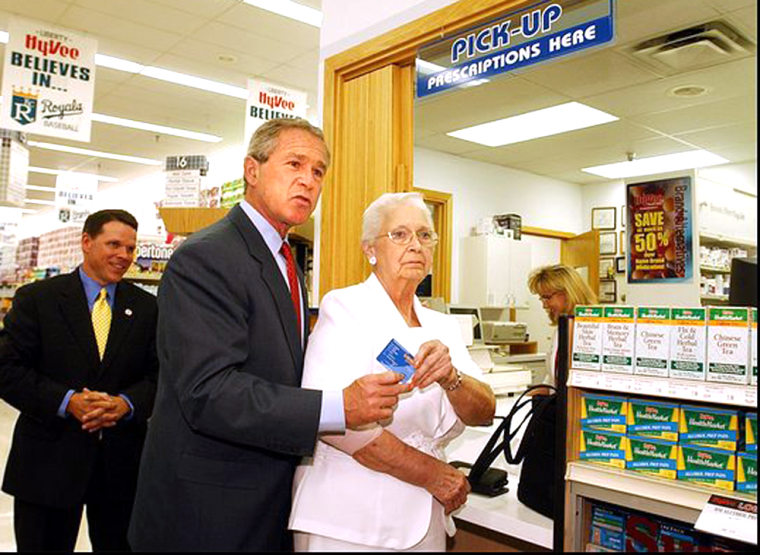 President Bush goes to pick up a prescription with Wanda Blackmore of Kansas City, Mo., at the Hy-Vee Pharmacy in Liberty, Mo., on June 14.
