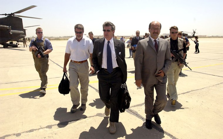Ambassador L. Paul Bremer and Iraqi Deputy Prime Minister Barham Saleh walk to the Baghdad International Airport before the ambassador makes his final departure from Iraq on Monday June 28, 2004. Earlier in the day the ambassador signed the Iraqi Sovereignty document which gave full governmental authority to the Iraqi interim government. (AP Photo/Staff Sgt. D. Myles Cullen/U.S. Air Force)