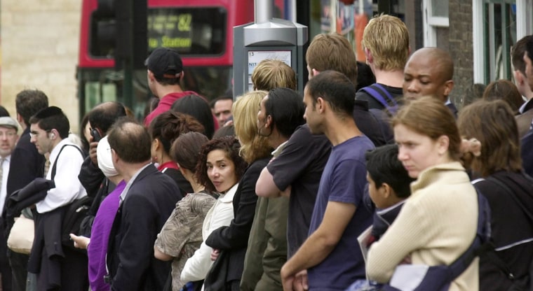 Crowds of commuters wait at a bus stop in North London, Wednesday. Londoners walked, biked, packed into overcrowded buses and crawled along in heavy traffic jams as a 24-hour subway drivers' strike made a mess of London's rush hour Wednesday morning.