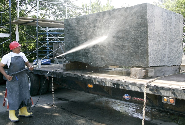 Manuel Hernandez of Innovative Stone in Hauppauge, N.Y., power washes a 20-ton hunk of granite Tuesday June 29, 2004, that will be used as the cornerstone that will mark the foundation of the 1,776-foot Freedom Tower at the site of the former World Trade Center. Construction on the skyscraper will officially begin Sunday July 4, 2004 after a ceremony featuring the reading of the Declaration of Independence by the son of a Port Authority police officer killed on Sept. 11, 2001. (AP Photo/Ed Betz)