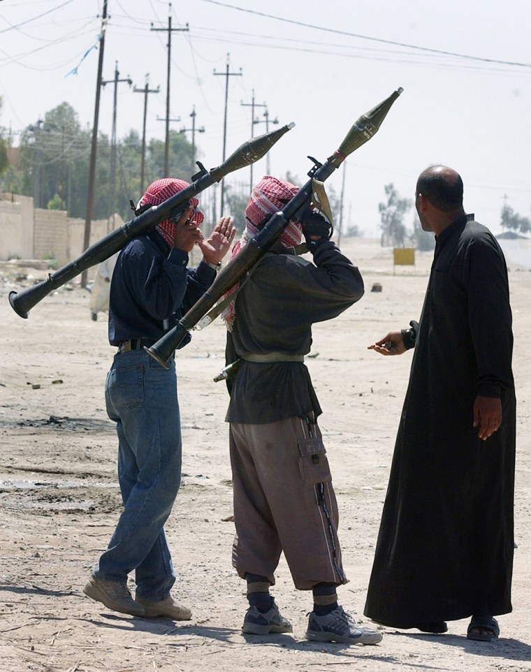 Sunni insurgents guard the streets of Fallujah, Iraq, on Wednesday.