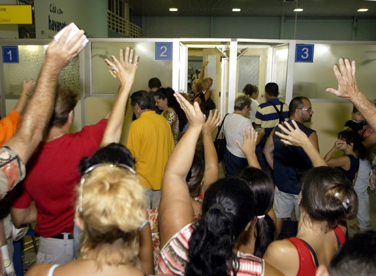 CUBANS WAVING GOOD BYE TO CUBAN AMERICAN FAMILY MEMBERS AT HAVANAS AIRPORT