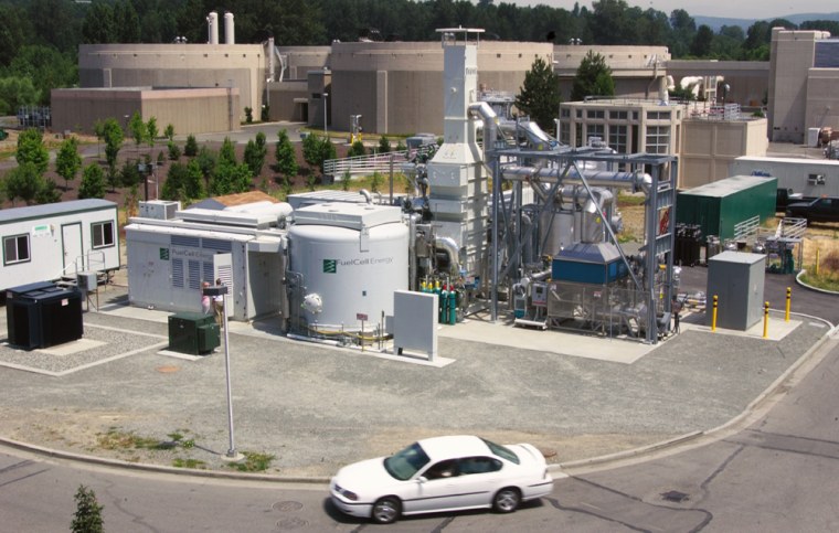 The fuelcell power plant at the waste water treatment plant in Renton, WA. Four large digester tank are shown in backgound.