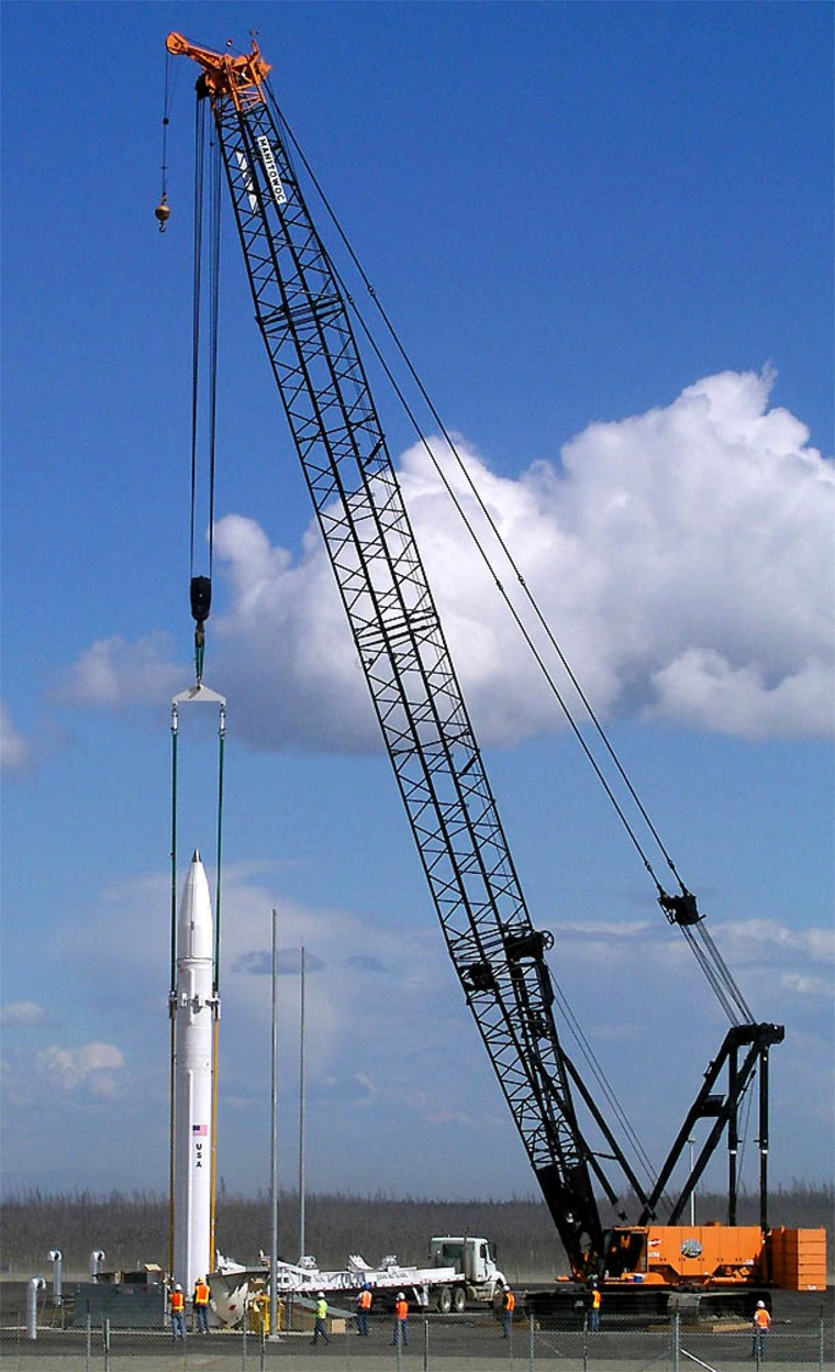 Workers lower a ground-based missile interceptor into its silo Thursday at Fort Greely near Delta Junction, Alaska, on Thursday July 22, 2004. The interceptor is the first component of a national defense system designed to shoot down enemy missiles.