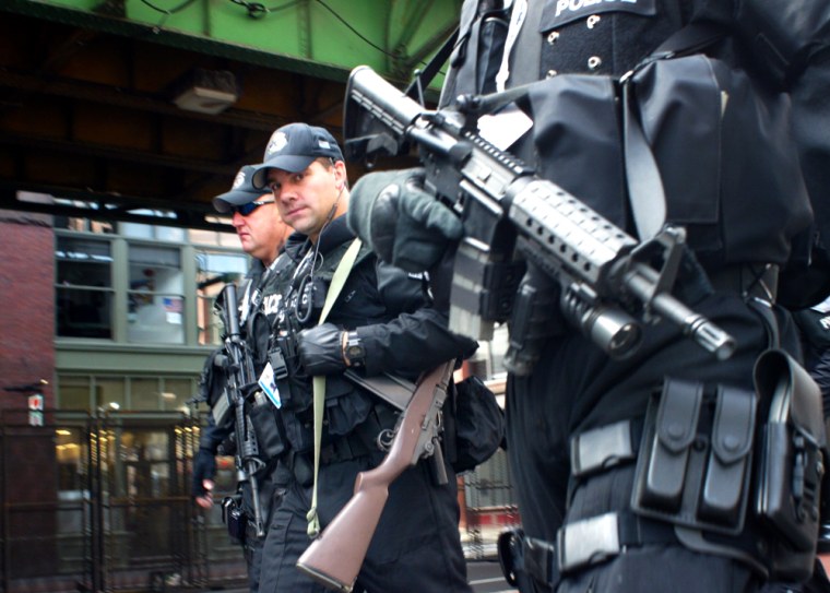 Armed security personnel patrol the streets outside the FleetCenter in Boston on Sunday.