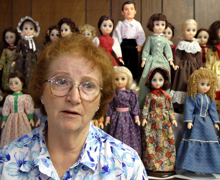 Colleen Ralson stands in front of her doll collection representing Mormon church founder Joseph Smith and his 49 wives. She aims to “educate, evangelize and encourage” Mormons to convert to more conventional forms of Christianity.