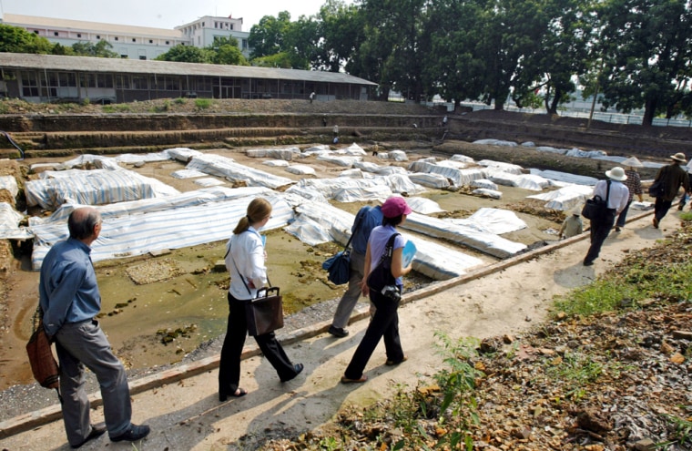Experts on archaeology and conservation on Tuesday survey segments of Vietnam's historic citadel, covered by burlap tarp.