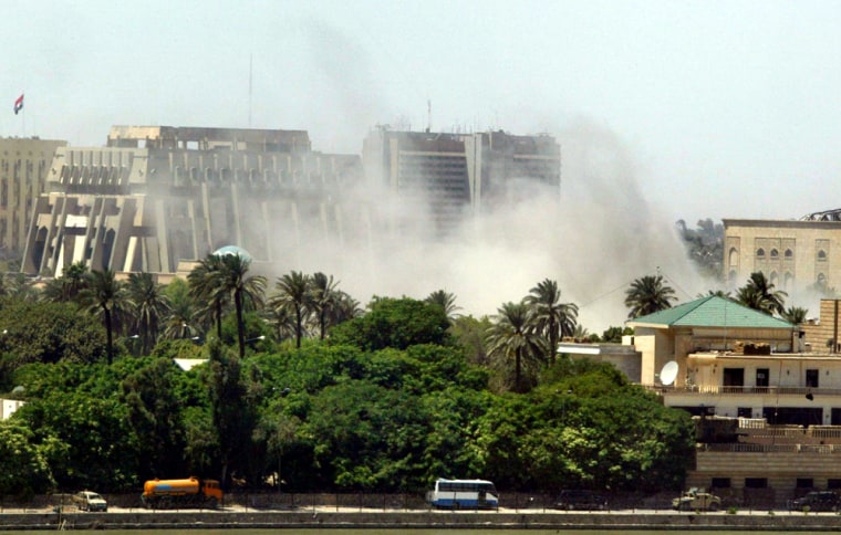 Smoke rises from the site of one of several explosions in central Baghdad on Sunday.