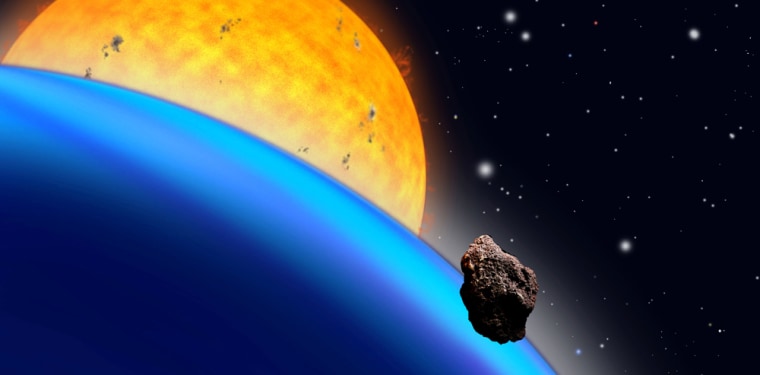 This artist's conception shows a close-up of the planet known as TrES-1 with its parent star in the background, and a rocky asteroid in the foreground.