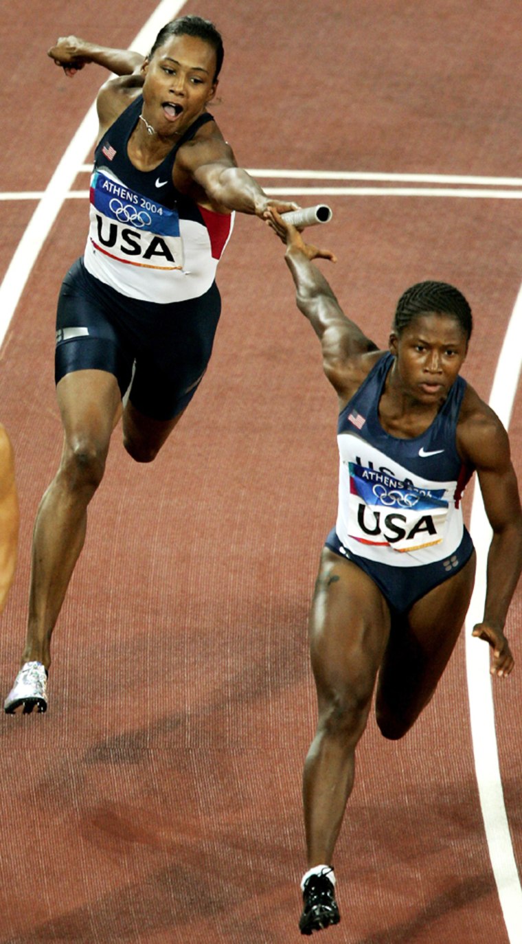 Marion Jones of the U.S. relay team fails to pass on the baton to Lauryn Williams in  the women's 4 x 100 metres relay final at the Athens Olympics