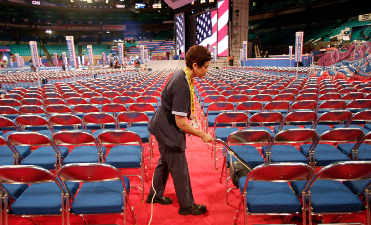 Woman vacuums the floor at Republican National Convention