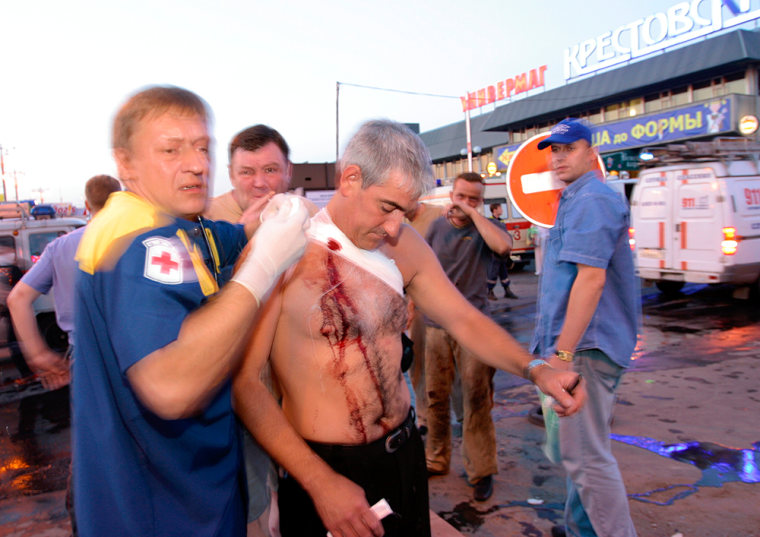 A man wounded in the explosion outside a Moscow subway station is treated at the scene Tuesday.