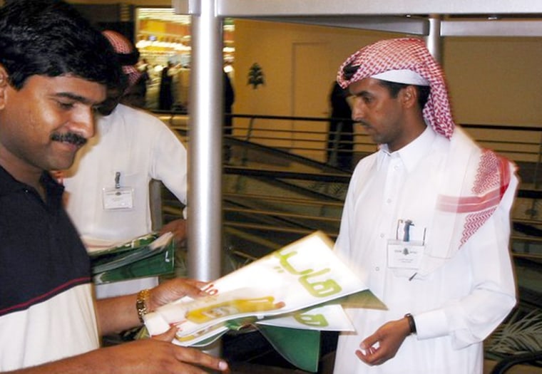 Fahad Amri, a 34-year-old Saudi, greets shoppers at the new Azizia Mall. Such service jobs have traditionally been held by foreign workers. 
