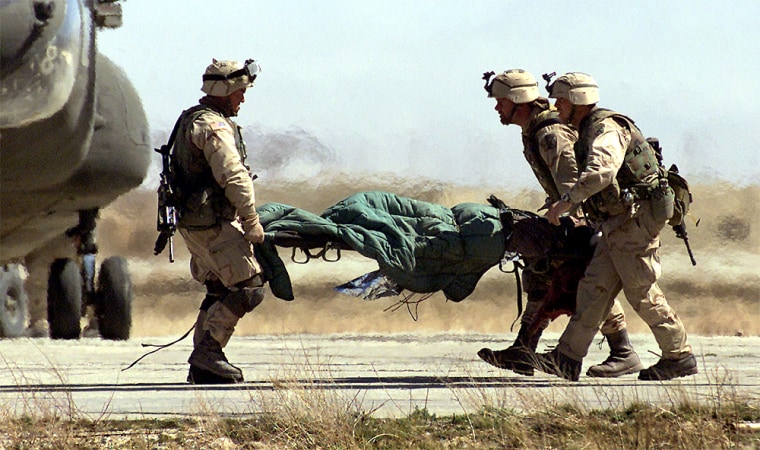 US SOLDIERS IN BAGRAM CARRY INJURED PRISONER