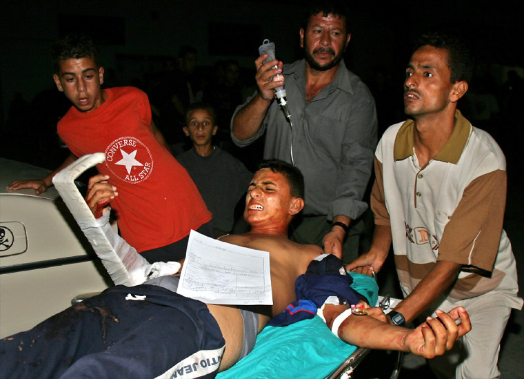 Palestinians wheel into hospital a wounded man from Khan Younis refugee camp in the Gaza