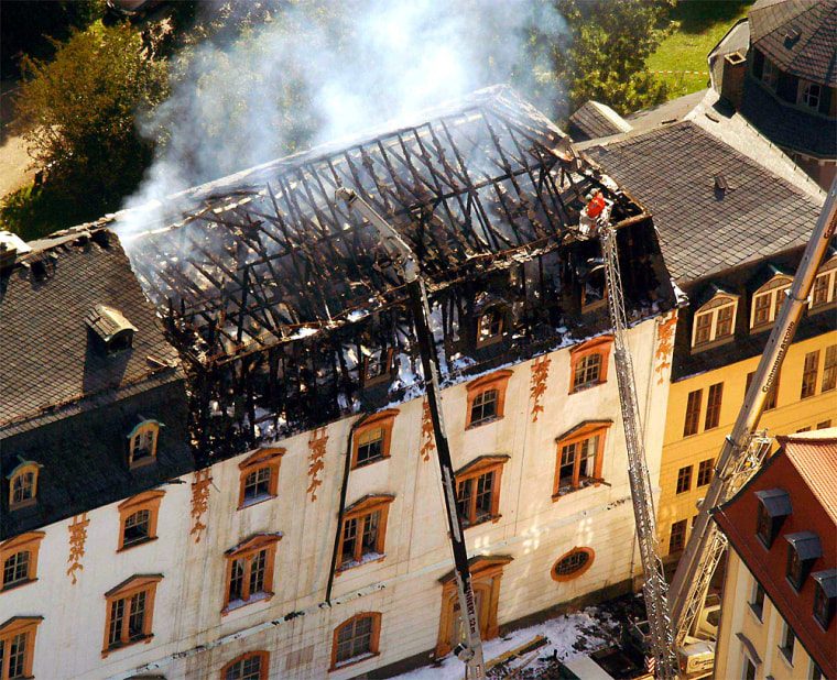Firemen examine the roof truss of the Duchess Anna Amalia library in Weimar, Germany, Friday after the fire.