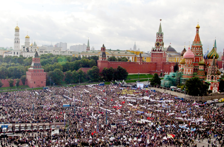 Demonstrators rally against terrorism  in the area next to St.Basil's Cathedral, right, on Red Square in Moscow, Tuesday, Sept. 7, 2004. Tens of thousands of Russians massed outside the Kremlin for a rally against terrorism Tuesday, responding to government calls for unity after a series of deadly attacks while mourners in Beslan lowered caskets into the damp earth at a cemetery burgeoning with victims of a school siege that claimed more than 350 lives. (AP Photo/Mikhail Metzel)