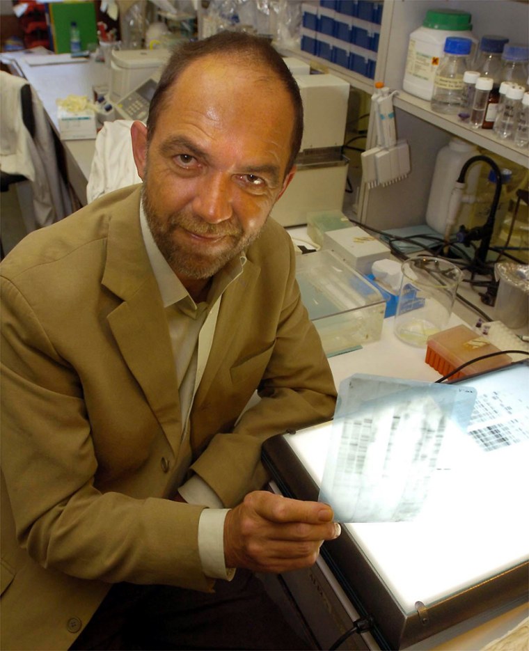 Professor Alec Jeffreys holds a copy of the first DNA fingerprint profile at the University of Leicester on Wednesday. Jeffreys, the scientist who discovered genetic "fingerprinting" two decades ago, says he has some concerns about the use of the technology.