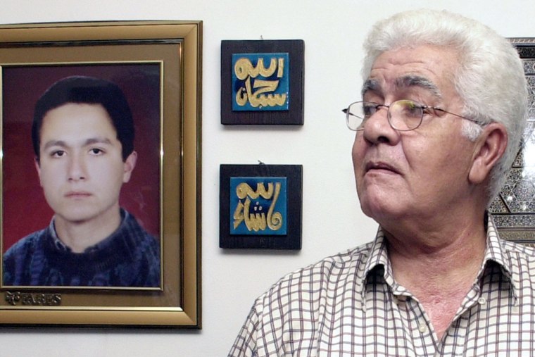 Mohammed al-Amir Atta, the father of the man accused of being the lead hijacker in the Sept. 11, 2001, attacks on New York and Washington, stands near a photograph of his son at his home in Cairo, Egypt.