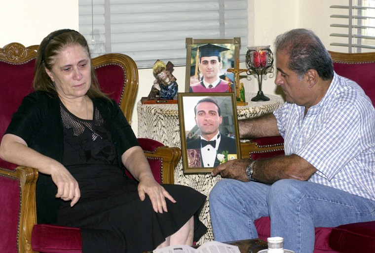 Yvette Moussa weeps as her husband Joseph holds a portrait of their son Jude, who died in the Sept. 11 terrorist attacks in New York, at their home in the northern Lebanese town of Kousba, on Sept. 6.