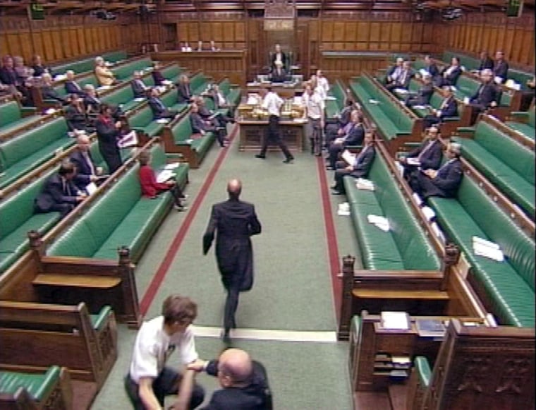TV grab shows protesters opposed to ban on fox hunting entering floor of Britain's parliament in London