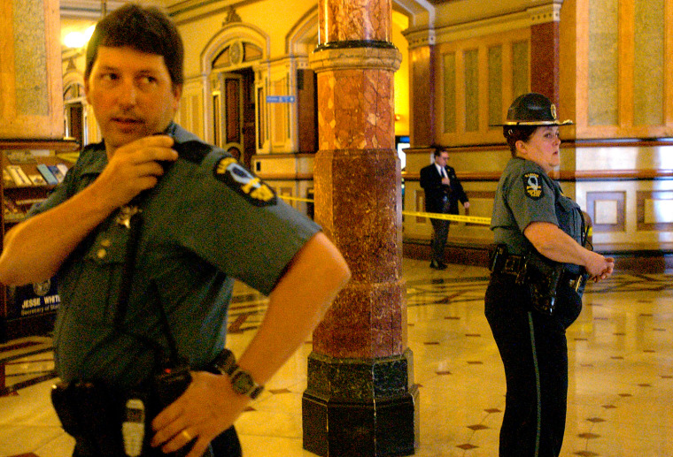 Illinois state police secure the rotunda of the state Capitol on Monday after an unarmed security guard was shot inside the entrance in Springfield, Ill.