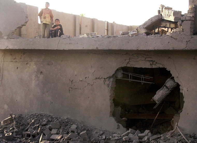 Children sit on the roof of their home after an air raid in Fallujah, Iraq, in early September.