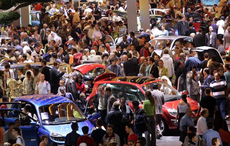Thousands of visitors look at cars on display at the Paris Mondial de l Automobile