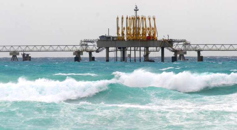 Battering waves continue to pound the oil groins in the shore of Grand Bahama Island