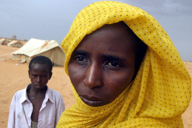 Aisha Haroon Mohamed, a Sudanese Arab married to an African, stands with her son, Mahamat Ibrahim, at a refugee camp in Chad.