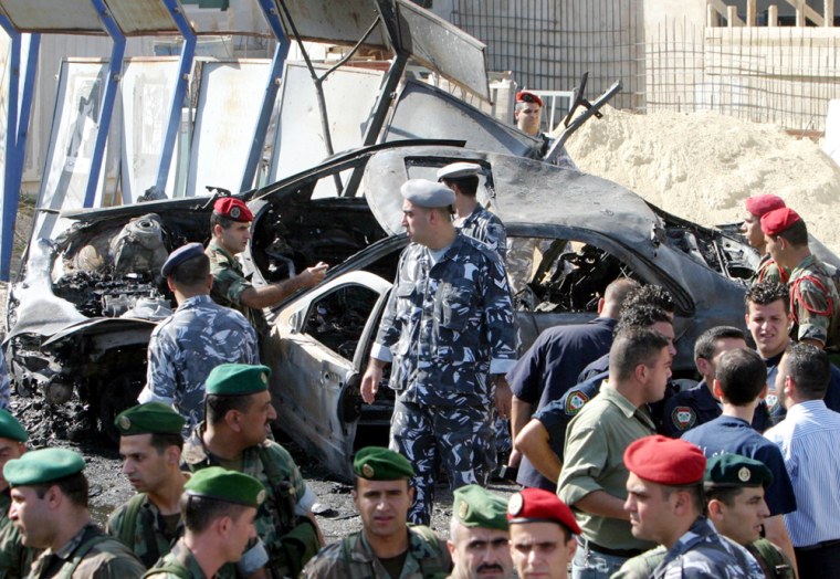 Lebanese security inspects the car of former Lebanese Cabinet minister Marwan Hamadeh, which was damaged by an explosion in Beirut, Lebanon, on Friday.