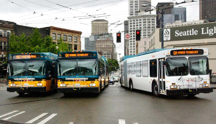 Drivers take three of the 235 hybrid buses through the streets of Seattle, WA for a test run, Wednesday May 26, 2004, as General Motors begins delivery to Kings County Metro Transit. The largest U.S. fleet of buses using GMs hybrid propulsion technology will save 750,000 gallons of fuel each year. 
Photo:Joe Polimeni/General Motors