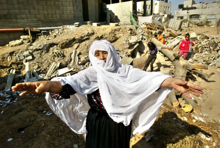 Palestinian woman shouts near her demolished home in Gaza Strip
