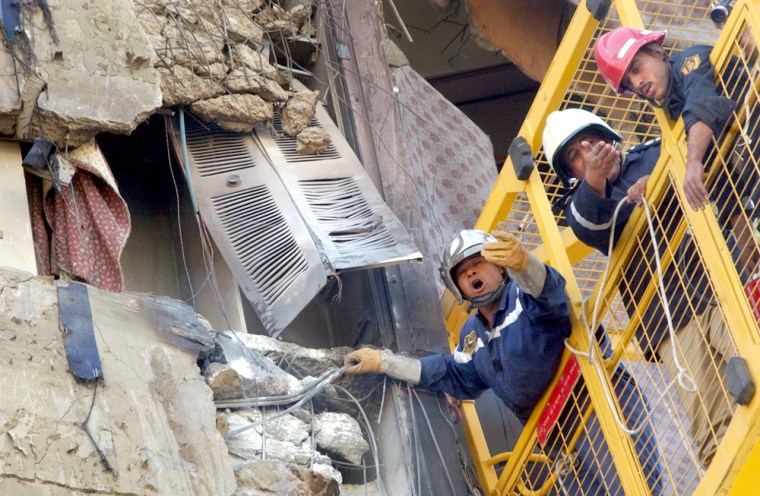 Egyptian rescue workers search one of the floors of the damaged Hilton Taba Hotel, on Saturday. 