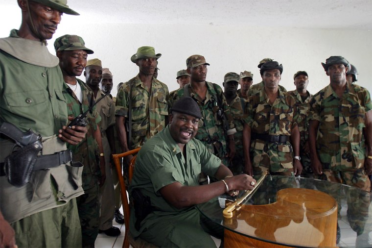 Former soldier and rebel leader Remissainthe Ravix, surrounded by more than 20 of his men, during an interview in Port-au-Prince, Haiti, Wednesday.