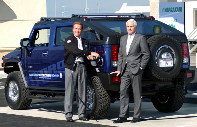 California Gov. Arnold Schwarzenegger tops off the first Hydrogen Hummer at the dedication Friday of a hydrogen fueling station at Los Angeles International Airport. At right is GM Vice Chairman Bob Lutz.