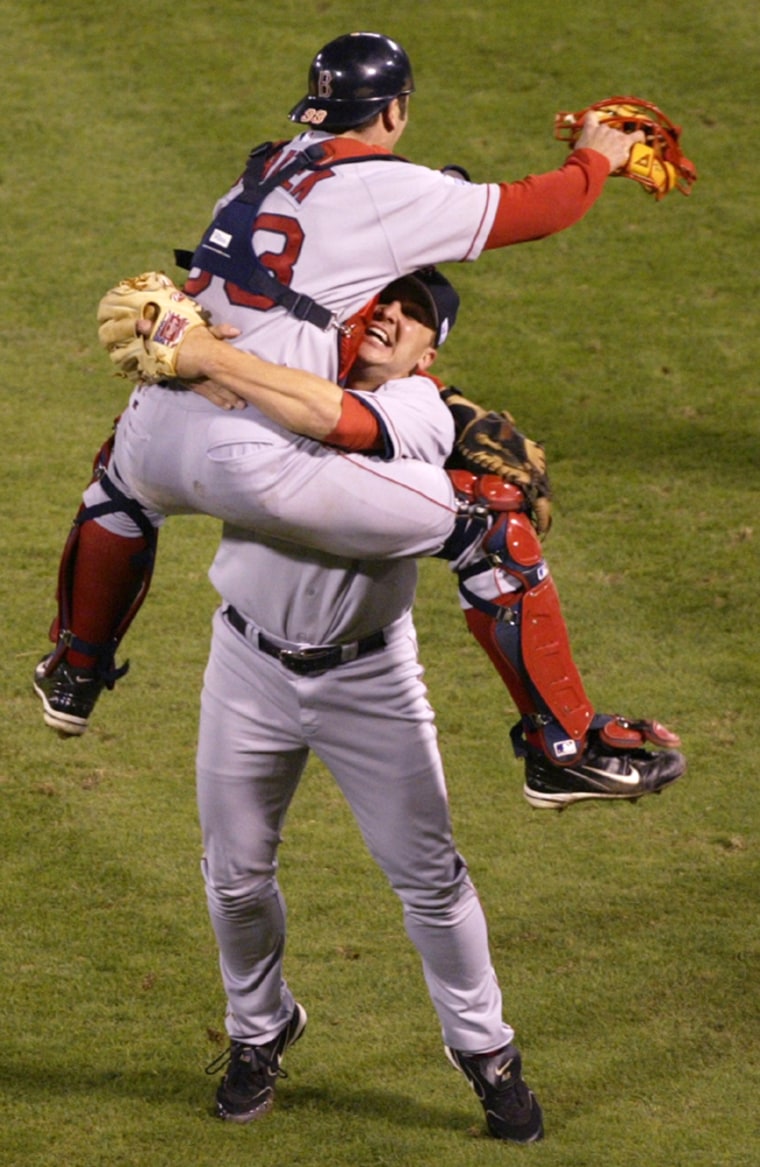 Red Sox players Keith Foulke and Jason Varitek celebrate their World Series win over the Cardinals